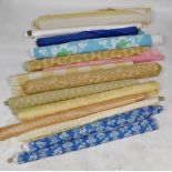 Various bolts of fabric, to include leaf decorated, yellow and blue striped, floral printed, etc. (a