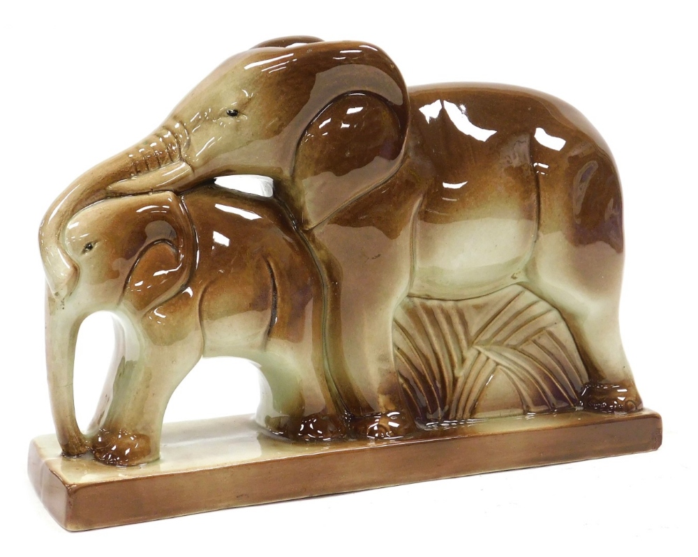 An early 20thC French pottery figure group, by Charles Lemanceau, of a mother and baby elephant, rai