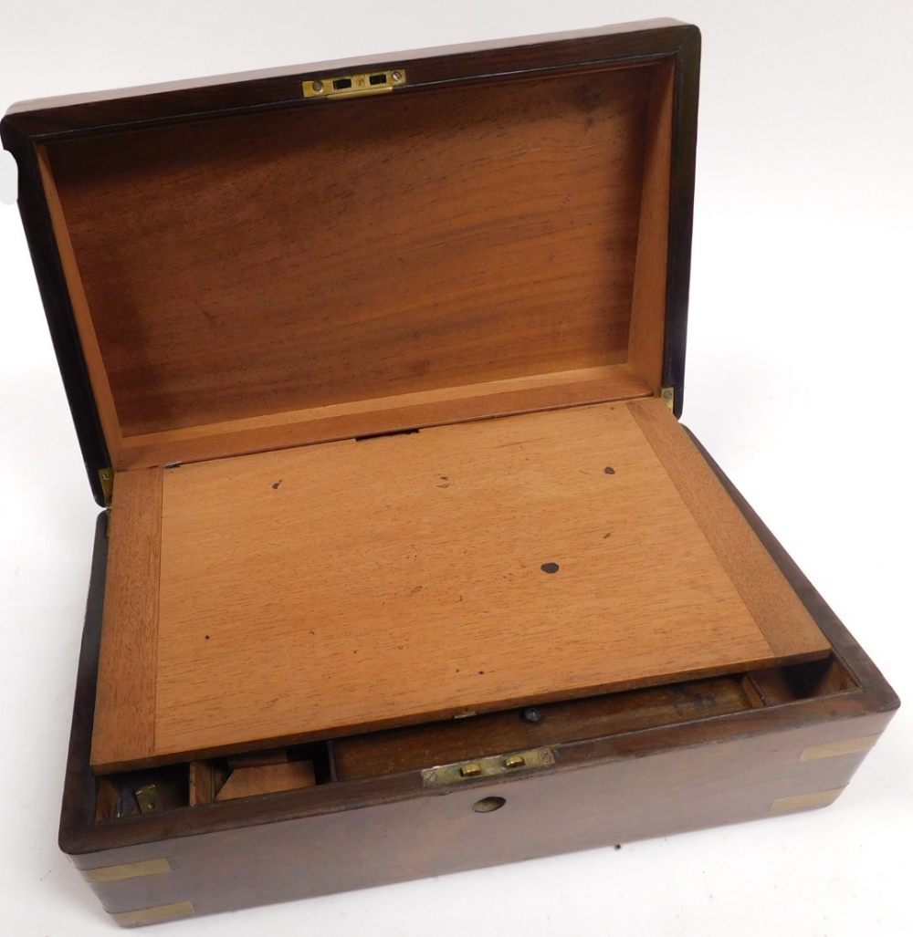 A Victorian walnut and brass bound writing slope, the hinged lid opening to reveal a slope and fitte - Image 3 of 5