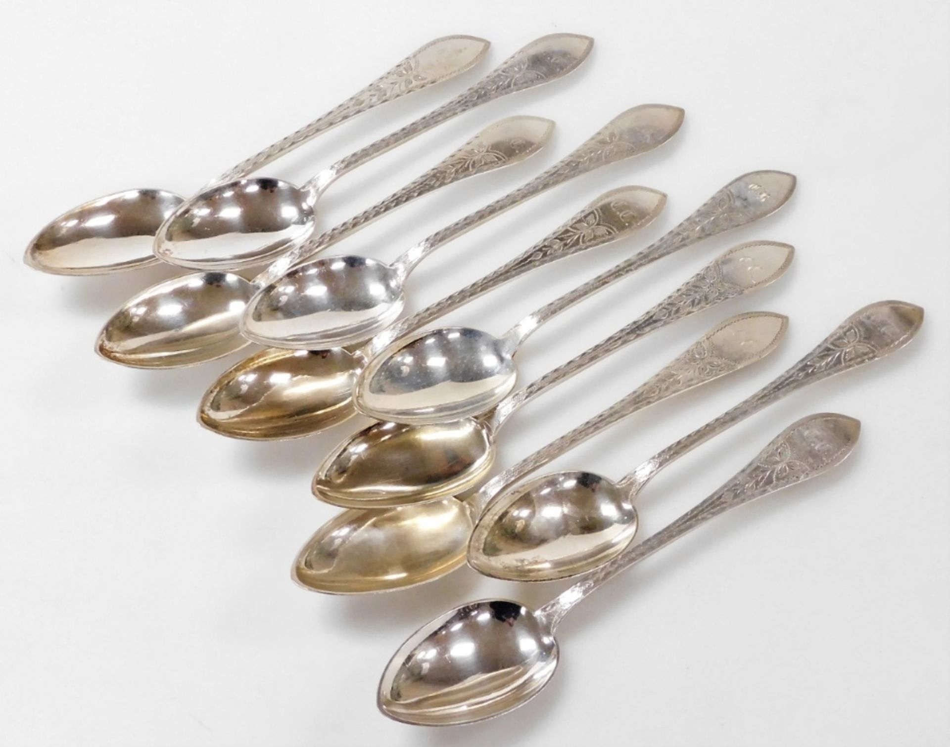 A set of ten Meyer Danish silver dessert spoons, foliate engraved, shield reserve monogram engraved,