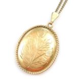 A 9ct gold oval double photo locket, floral engraved, on a curb link neck chain stamped 9ct, 14.8g.