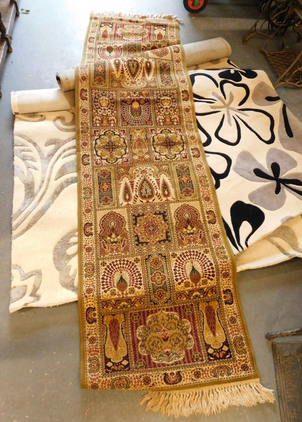 Two abstract floral patterned rugs, together with a runner.