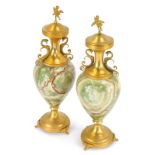 A pair of Italian green onyx and gilt urns and covers, each with a circular lid bearing cherub finia