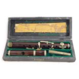 A rosewood cased picccolo, by Hawkes & Son, Denim Street of London, cased.