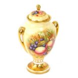 An Aynsley Orchard Gold pattern twin handled vase and cover, painted with fruit by D Jones, with gil