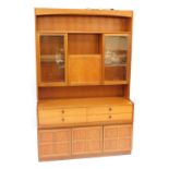 A late 20thC Nathan teak lounge unit, the top with two glazed sections and a fall front panel door,