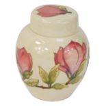 A Moorcroft Magnolia pattern ivory ground jar and cover, with green Moorcroft stamp and WM to unders