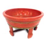 An Oriental lacquer bowl raised on legs, 66cm diameter.
