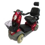 A TGA Mystery DX red mobility scooter, with battery.