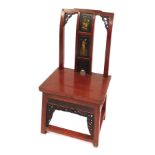 A Chinese lacquer chair, with gilt figures to the splat and pierced framing, drawer to seat, 84cm hi