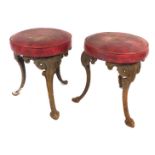 A pair of cast iron bar stools, with outsplayed cabriole legs, 44cm high.