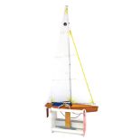 A radio controlled wooden model of a racing yacht Nimbus, with a wooden stand, 100cm, wide.