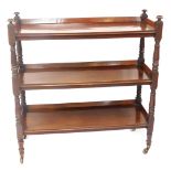 A Victorian mahogany three tier buffet, with galleried top, and turned supports, on castors, 120cm h