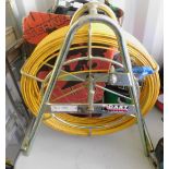 A Dart Systems aluminium cable layer and reel of yellow cabling. Note: VAT is payable on the hammer