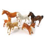 A group of Beswick and other animal ornaments, comprising a Beswick palomino horse, 19cm high, a Bes