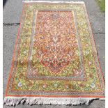 A Kashmir red and green ground prayer rug, the mihrab filled with a tree of life, within repeating f