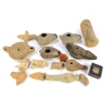 A collection of Roman and other terracotta and earthenware oil lamps, funerary figures, etc., mixtur