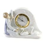 A Lladro girl and swan table clock, numbered 5777, printed and impressed marks beneath, 17cm high.