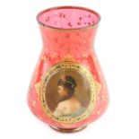 A Bohemian ruby tinted glass vase, with applied plaque painted with a lady in profile, within gilt l