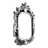 A Venetian wall mirror, the shaped plate with a bevelled edge, the frame with blue mirrored inset an