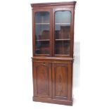 A Victorian mahogany bookcase, with moulded cornice, two glazed doors over two panelled doors and pl