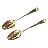 A pair of George III silver spoons, old English pattern, with feathered borders, initialled MC, 18th