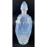 A Sabino glass perfume bottle, raised with figures of semi clad ladies, script mark and label beneat