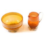 A 19thC Nailsea style miniature milk jug and sugar bowl, in amber coloured glass with a white lined