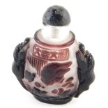 A Chinese Peking glass snuff bottle, with animal handles in purple on frosted glass ground with comp