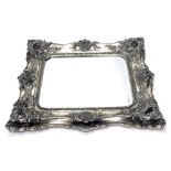 A large silvered rococo style wall mirror, rectangular bevelled plate, the frame decorated with scro