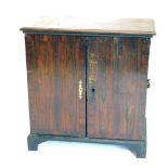 An early 19thC mahogany and rosewood collectors cabinet, with two cross banded doors (AF), 90cm high