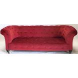 A Victorian walnut Chesterfield sofa, with red buttoned upholstery, 200cm wide.
