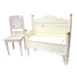 A cream painted bench, with hinged seat on turned legs, with gilt highlights, 104cm high, 101cm wide