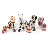 Various Staffordshire pottery spaniels, standing cat with blue bow, the body picked out in black, 44