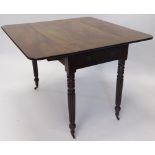 A William IV mahogany Pembroke table, with frieze drawer on reeded legs terminating in brass castors