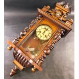 An early 20thC walnut cased Vienna wall clock, the 11cm diameter Roman numeric dial fronting an eigh