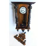 A late 19th/early 20thC Vienna wall clock, in a walnut and ebonised case, the enamel dial with Roman