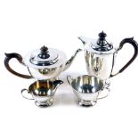 A George V silver four piece tea service, by A W Benson Ltd, comprising water jug, 23cm high, teapot