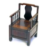 A Chinese hardwood child's commode chair.