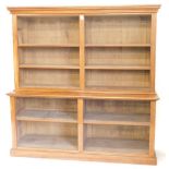 A Victorian satin birch and walnut open bookcase, with moulded cornice, adjustable shelves to the up