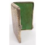 An Edward VII silver pocket card case, with green leather fitted interior for stamps and calling car