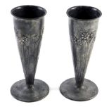 A pair of early 20thC Christopher Dresser design English pewter vases, raised with trees, numbered 0