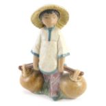 A Lladro ceramic figure of an Oriental child carrying water, 19cm high.