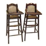 A pair of child's highchairs, with caned backs and seats.