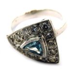 An 18ct white gold dress ring, with triangle shaped design, with a central blue zircon, in rub over