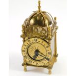 A 20thC Smiths Clocks and Watches brass miniature lantern clock, with bell top, 8cm diameter Roman n