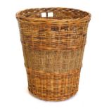 A 20thC wicker log basket, 58cm high, 51cm diameter.