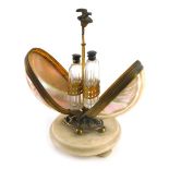 A 19thC Continental and gilt metal shell and marble scent bottle holder, of egg form on bun feet, 22