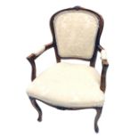 A 20thC French walnut fauteuil, with cream upholstered back, arm rests and seats, on cabriole legs.