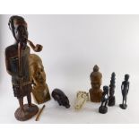 A collection of carved African hardwood figures, to include a tall figure with staff, rhino, etc.